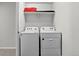 Efficient laundry room with washer, dryer, and convenient shelving for storage at 5336 Trails Edge Ln, Castle Rock, CO 80104