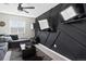 A living room provides a sofa, coffee table, three televisions mounted on a custom wall, and a ceiling fan at 5336 Trails Edge Ln, Castle Rock, CO 80104