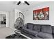 A living room provides a sofa, coffee table, a hanging chair, and a piece of artwork at 5336 Trails Edge Ln, Castle Rock, CO 80104
