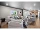 Spacious living room with ample seating, modern decor, and open layout to kitchen and dining area at 5336 Trails Edge Ln, Castle Rock, CO 80104