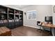 Bright home office with built-in bookcases and a large window offering plenty of natural light at 5336 Trails Edge Ln, Castle Rock, CO 80104
