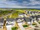 A panoramic view of a neighborhood with modern homes, green spaces, and a distant lake at 9374 Quartz St, Arvada, CO 80007