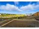 Spacious, undeveloped backyard featuring new wood fence and panoramic views of the surrounding landscape and community at 9374 Quartz St, Arvada, CO 80007