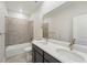 Modern bathroom featuring double sinks, a large mirror, and a shower-tub combo, creating a spa-like experience at 9374 Quartz St, Arvada, CO 80007
