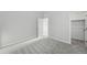 Bedroom featuring plush carpeting, light colored walls, and open closet and doorway at 9374 Quartz St, Arvada, CO 80007