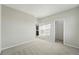 Bedroom featuring gray carpet, neutral walls and an open doorway to the bathroom at 9374 Quartz St, Arvada, CO 80007