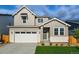 Charming two-story home with a mix of siding and stone, plus an attached two-car garage at 9374 Quartz St, Arvada, CO 80007