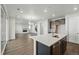 Open concept kitchen with stainless steel appliances and a living room with a fireplace, perfect for modern living at 9374 Quartz St, Arvada, CO 80007