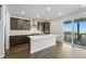 Modern kitchen with a large island, stainless steel appliances, and a sliding glass door to a balcony with amazing views at 9374 Quartz St, Arvada, CO 80007