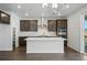 Modern kitchen with stainless steel appliances, granite countertops, center island, and ample cabinet space for storage at 9374 Quartz St, Arvada, CO 80007