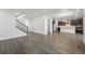 Spacious open-concept living area with hardwood floors seamlessly connecting the living room, dining area, and kitchen at 9374 Quartz St, Arvada, CO 80007
