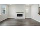 Living room showcasing hardwood floors, a modern fireplace, and multiple windows offering abundant natural light and scenic views at 9374 Quartz St, Arvada, CO 80007