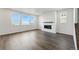 Bright living room showcasing hardwood floors, a modern fireplace, and multiple windows offering abundant natural light at 9374 Quartz St, Arvada, CO 80007