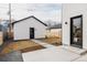 A backyard with a detached garage, modern fence, and concrete pavers leading from the house at 4135 Benton Street, Denver, CO 80212