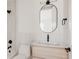 Well-lit bathroom featuring an oval mirror, contemporary vanity, and modern fixtures at 4135 Benton Street, Denver, CO 80212