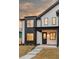 Close-up of a stylish home entrance featuring black trim, modern windows, and a well-lit covered porch at 4135 Benton Street, Denver, CO 80212