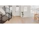 Inviting entryway with hardwood floors, a black metal railing, and a minimalist design at 4135 Benton Street, Denver, CO 80212