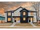 Stunning two-story homes with black and white exteriors, showcasing large windows and inviting front entrances at 4135 Benton Street, Denver, CO 80212