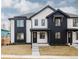 Modern two-story home with black and white accents, large windows, and a well-manicured front yard at 4135 Benton Street, Denver, CO 80212