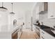 Bright, modern kitchen with white cabinets, black countertops, and stainless steel appliances at 4135 Benton Street, Denver, CO 80212