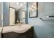 Bathroom features a modern sink, vanity and medicine cabinet with updated fixtures and a towel rack at 8731 Dawson St # 102, Denver, CO 80229