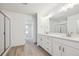 Main bathroom with double vanity and walk-in shower at 811 Goodrich Peak St, Erie, CO 80516