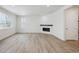 Living room with hardwood floors, fireplace and sliding glass doors at 811 Goodrich Peak St, Erie, CO 80516