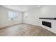 Living room with hardwood floors, fireplace and sliding glass doors at 811 Goodrich Peak St, Erie, CO 80516