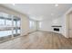 Living room with hardwood floors, fireplace and sliding glass doors at 811 Goodrich Peak St, Erie, CO 80516