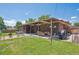 Large yard with a covered patio, a brick patio, and a lush lawn for relaxation and entertainment at 1774 S Dover Way, Lakewood, CO 80232