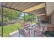Spacious covered patio with comfortable seating and a large, meticulously kept backyard at 1774 S Dover Way, Lakewood, CO 80232