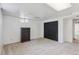Basement bedroom with neutral carpet, a storage dresser, and a large black closet at 1774 S Dover Way, Lakewood, CO 80232