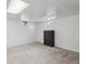 Spacious basement bedroom featuring neutral carpet, white walls, and a storage dresser at 1774 S Dover Way, Lakewood, CO 80232