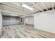 Finished basement featuring gray-tone laminate flooring and built-in shelves at 1774 S Dover Way, Lakewood, CO 80232