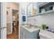 Bathroom featuring blue-gray cabinets with light countertop and plants for decoration at 1774 S Dover Way, Lakewood, CO 80232