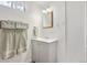 Simple downstairs bathroom with a basin sink vanity and a decorative mirror at 1774 S Dover Way, Lakewood, CO 80232