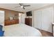 Bedroom with hardwood floors, closet, ceiling fan and tv above a dresser at 1774 S Dover Way, Lakewood, CO 80232