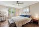 Bright bedroom featuring hardwood floors, a ceiling fan and 2 sunny windows at 1774 S Dover Way, Lakewood, CO 80232