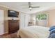 Bedroom with ceiling fan, hardwood floors, and a closet for ample storage at 1774 S Dover Way, Lakewood, CO 80232