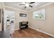 Bedroom featuring hardwood floors, a ceiling fan, neutral color palette, and an adjacent main bathroom at 1774 S Dover Way, Lakewood, CO 80232