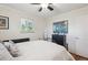 Cozy bedroom featuring a ceiling fan and a large framed painting on the dresser at 1774 S Dover Way, Lakewood, CO 80232