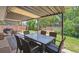 Charming covered patio with outdoor dining set and views of the lush backyard at 1774 S Dover Way, Lakewood, CO 80232