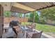 Covered patio with comfortable seating, a view of the large backyard, and a barbecue at 1774 S Dover Way, Lakewood, CO 80232