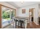 Bright breakfast nook with bar, overlooking a backyard and adjacent to the living area and the main hallway at 1774 S Dover Way, Lakewood, CO 80232