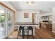 Bright dining area with breakfast bar overlooking a sliding glass door and connecting to a cozy living area at 1774 S Dover Way, Lakewood, CO 80232