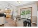 Bright dining room area leading to the kitchen, featuring updated wood flooring at 1774 S Dover Way, Lakewood, CO 80232