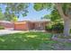 Charming single-story brick home with a well-maintained lawn and mature landscaping at 1774 S Dover Way, Lakewood, CO 80232