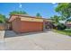 Spacious garage with an extended driveway and well-maintained landscaping at 1774 S Dover Way, Lakewood, CO 80232