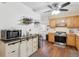 Well-appointed kitchen featuring oak cabinets, a stainless steel oven, and hardwood floors at 1774 S Dover Way, Lakewood, CO 80232