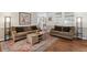 Open-concept living room featuring hardwood floors and neutral paint colors at 1774 S Dover Way, Lakewood, CO 80232
